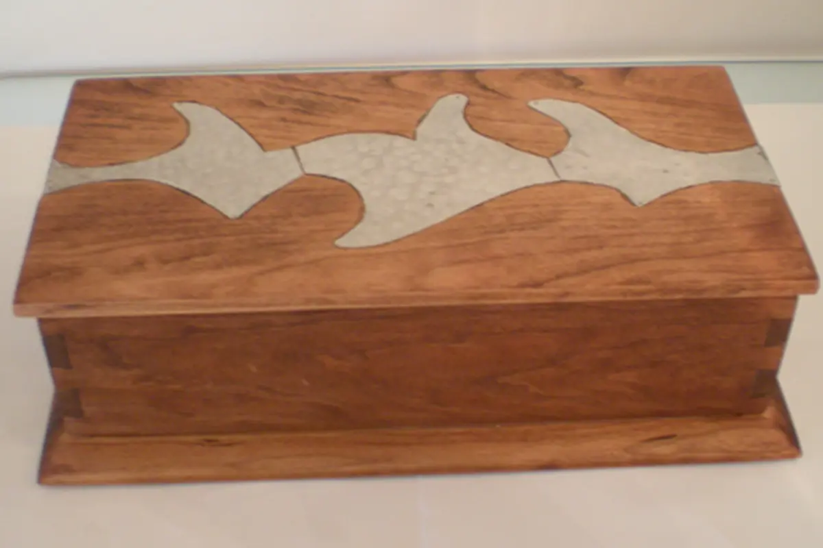 Wooden box with artistic inlay of abstract shapes.