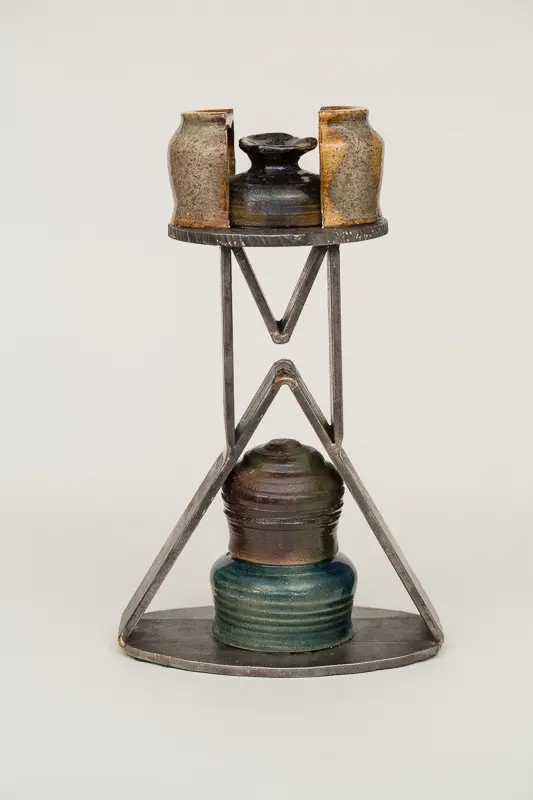 A vintage metal and glass lantern with a unique geometric frame.