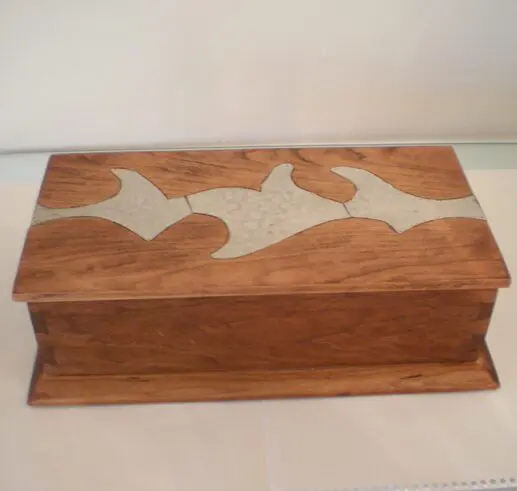 Wooden box with decorative inlay on the lid.