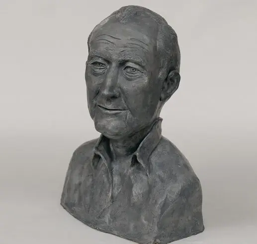 A bust sculpture of an elderly man with a contemplative expression.