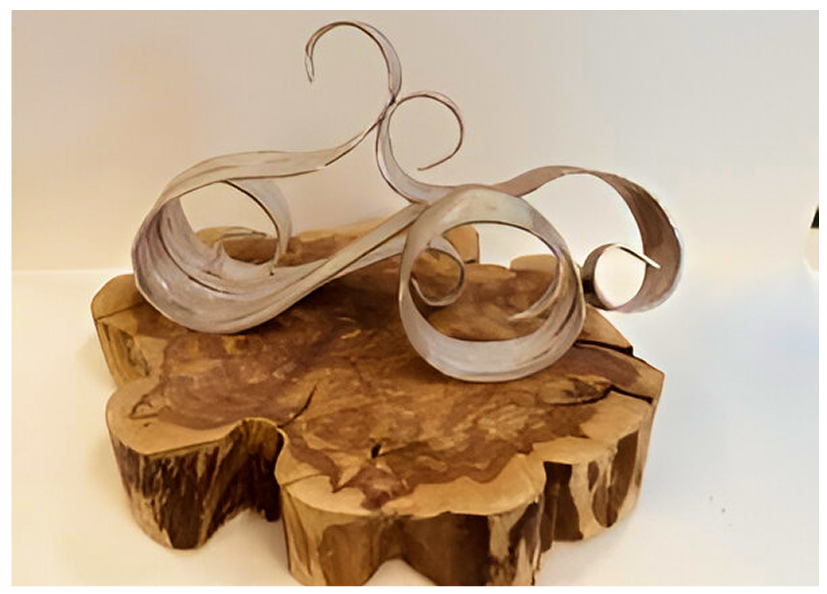 Two elegant glass sculptures on a wooden base.