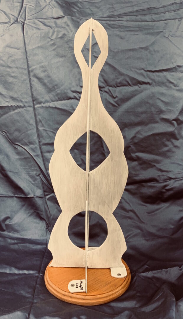 Wooden stringed instrument with two circular sound holes.