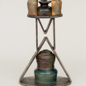 A vintage metal and glass lantern with a unique geometric frame.