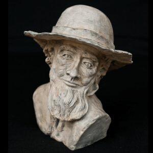 Bust sculpture of an elderly man with a hat and beard.
