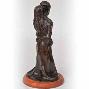 Bronze sculpture of a woman holding a child, standing on a wooden base.
