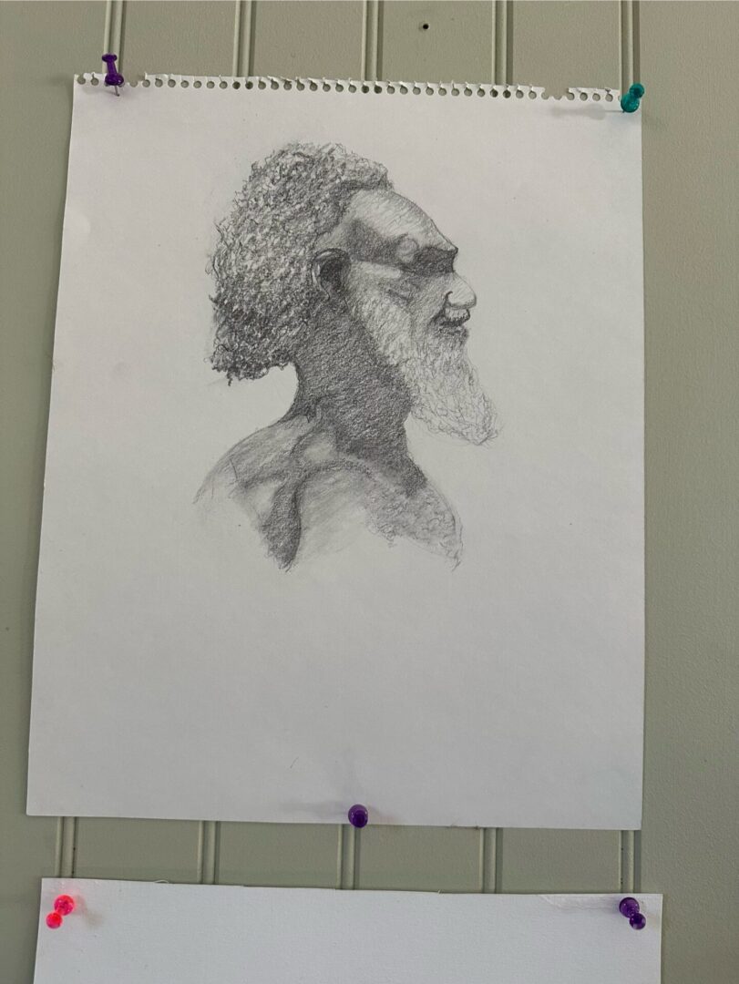 Detailed pencil sketch of a bearded man in profile.