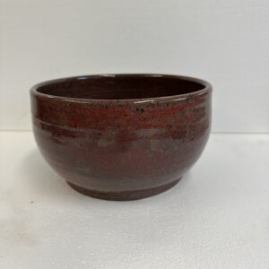 Brown ceramic bowl with a smooth finish on a white background.