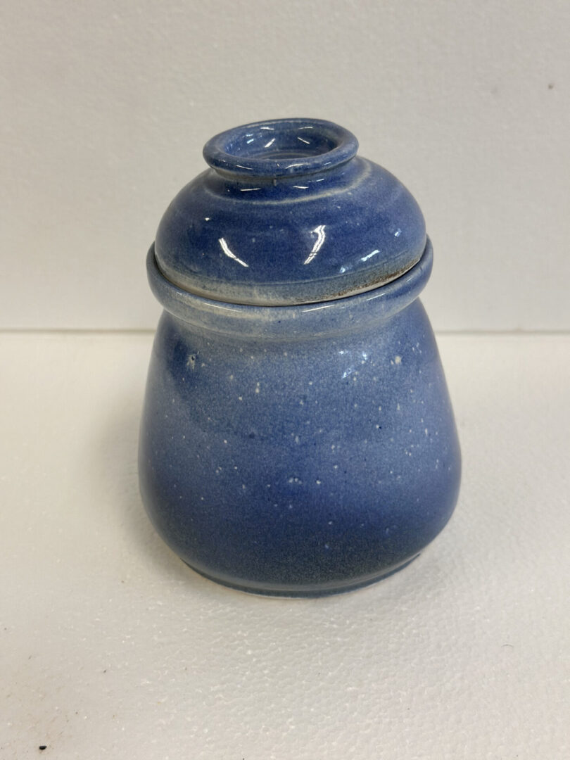 Small blue ceramic jar with a rounded lid.