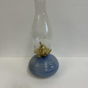 Vintage blue oil lamp with glass chimney on white background.