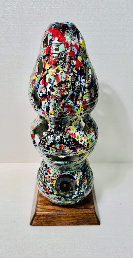 Colorful abstract sculpture with layered, rounded shapes and splattered paint.