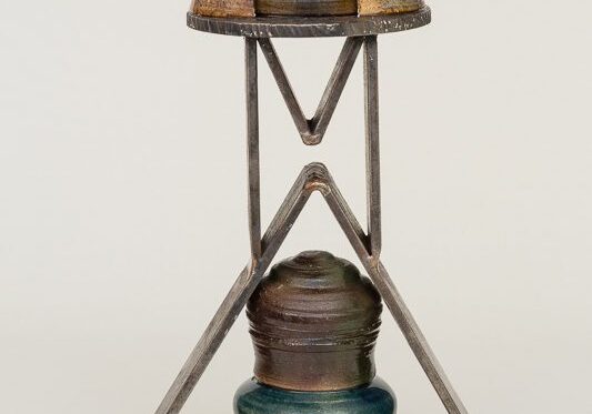 A vintage metal and glass lantern with a unique geometric frame.